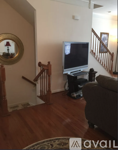 A living room with a television and a couch.