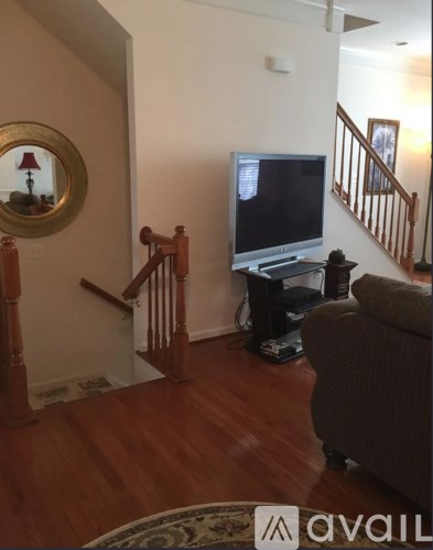 A living room with a television and a couch.