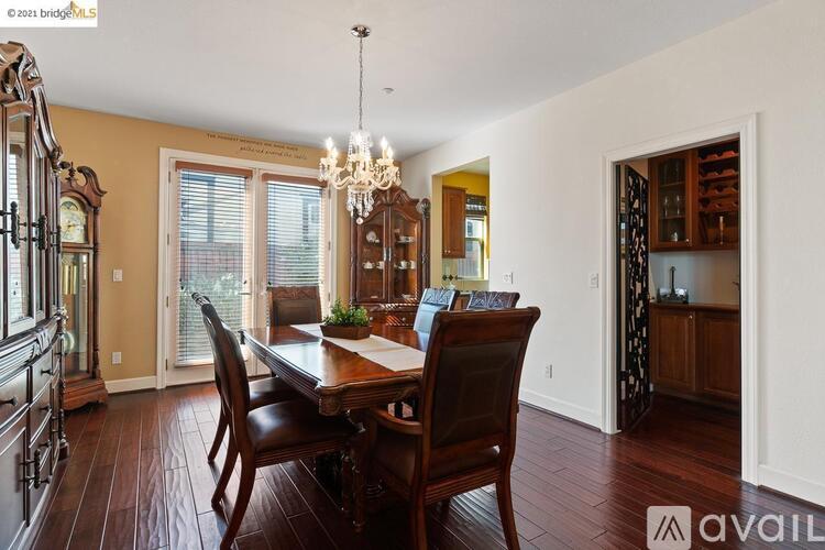 A dining room with a wooden table and chairs.