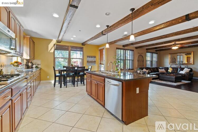 A kitchen with wooden cabinets and a large island.