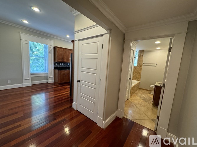 A room with wooden floors and a white door.