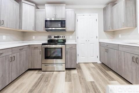 A kitchen with a stove top oven and microwave.