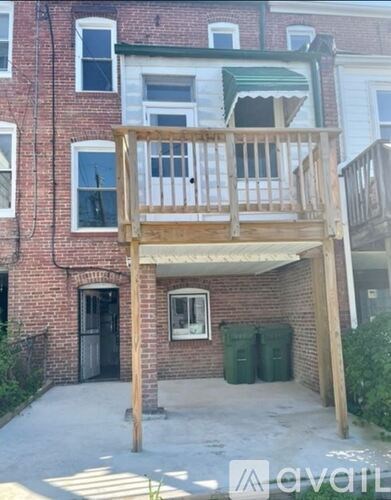 A wooden deck is attached to a brick building.