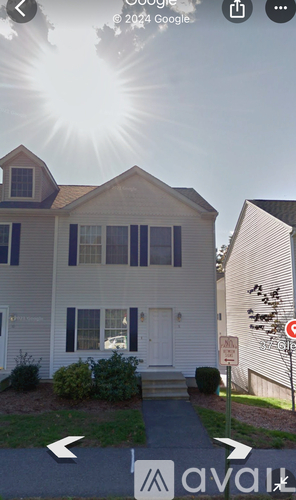 A house with a white door and a sign that says "No Parking".