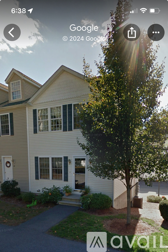A house with a tree in front of it.