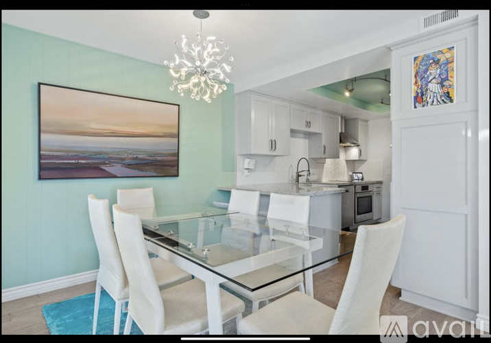 A dining room with a glass table and chairs.