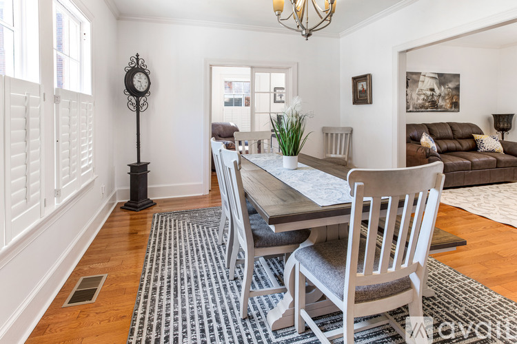 A dining room with a table set for four.