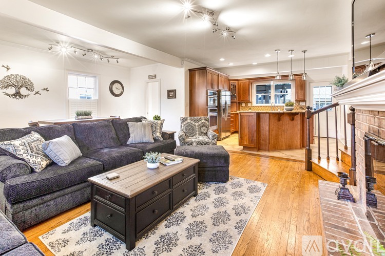 A living room with a grey couch and a wooden coffee table.