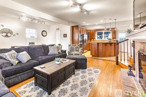 A living room with a grey couch and a wooden coffee table.