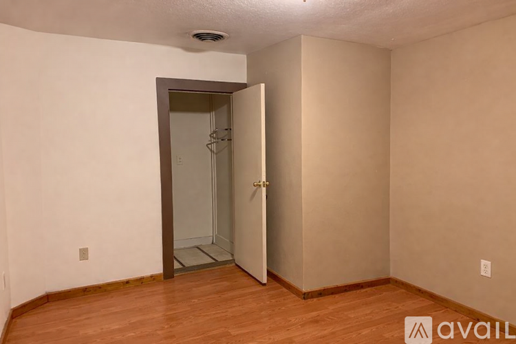 A room with a door and a wall socket.