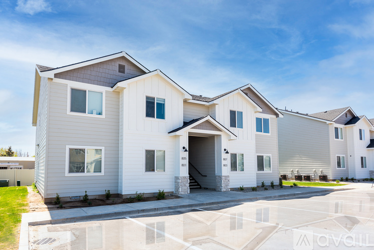 A row of modern houses with a clear blue sky above them.