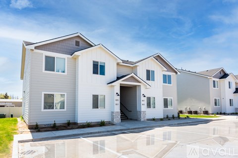 A row of modern houses with a clear blue sky above them.