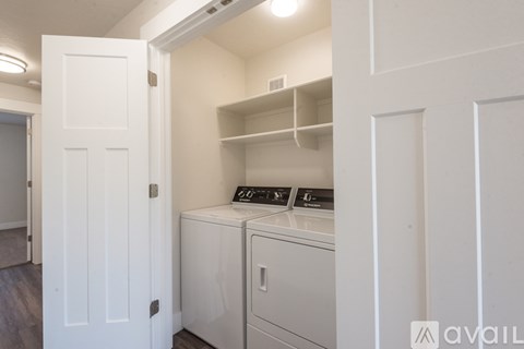 A small kitchen with a white door and a white cabinet.