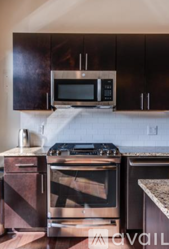 A kitchen with a stove top oven and microwave.