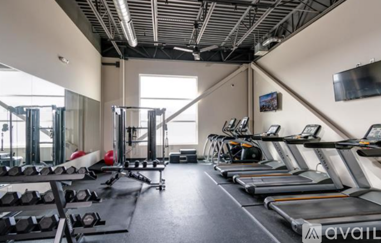 A gym with treadmills, weights, and exercise equipment.