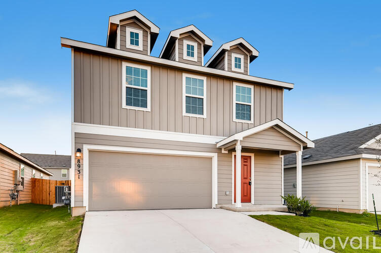 A modern house with a garage and a red door.