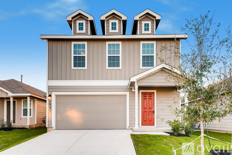 A modern house with a red door and a garage.