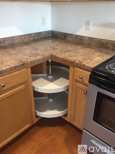 A kitchen with a granite counter top and a double oven.