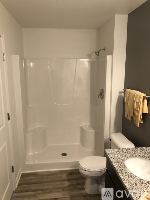 A white toilet sits next to a sink in a bathroom.
