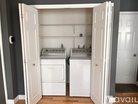 A small white kitchen with two sinks and a dishwasher.