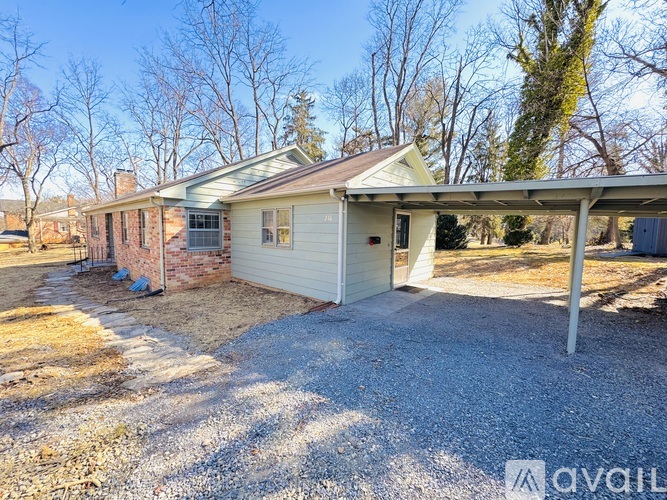 A house with a gravel driveway and a garage is for sale.