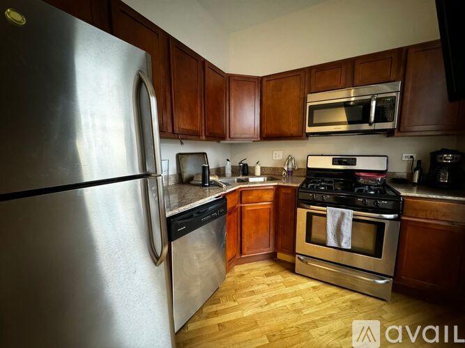 A kitchen with wooden cabinets and stainless steel appliances.