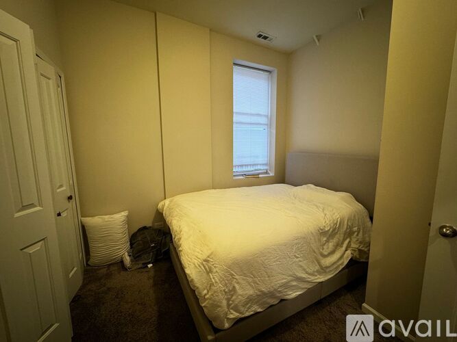 A bedroom with a bed, pillow, and window.