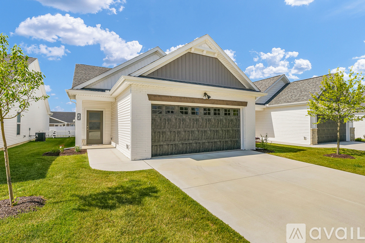 A modern house with a large garage door is for sale.