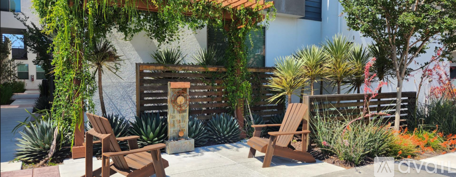 A wooden bench sits in front of a building with a sign that says "AVOID".