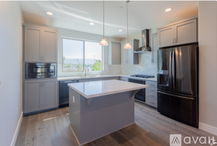 A modern kitchen with a large island in the center.