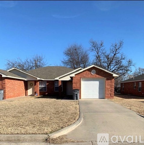 A house with a garage and a driveway in front.