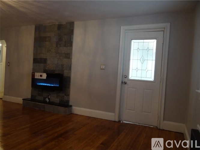A room with a fireplace and a door.