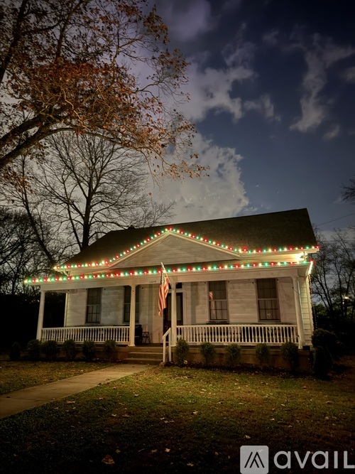 A house with Christmas lights on the porch.