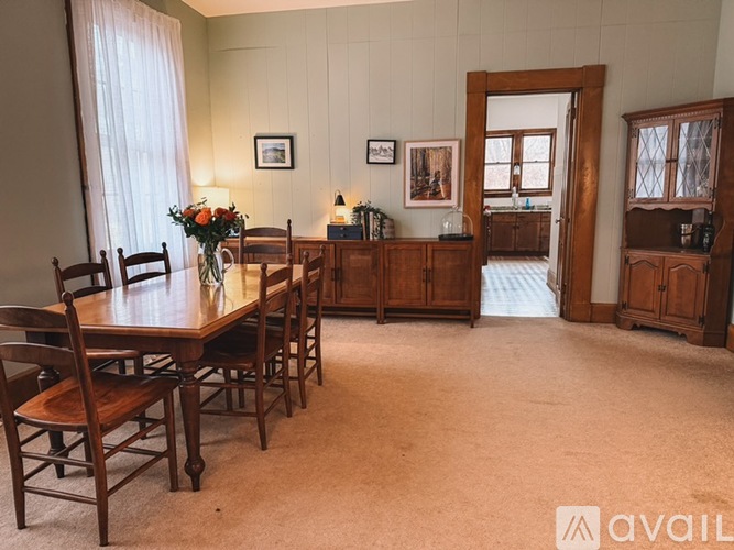 A dining room with a table set for four.