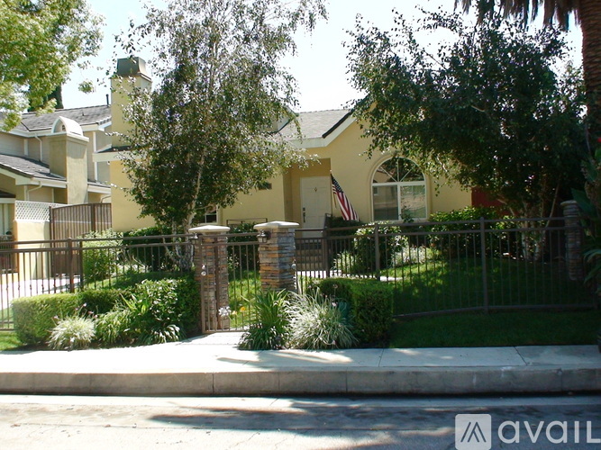 A house with a flag on the front lawn.