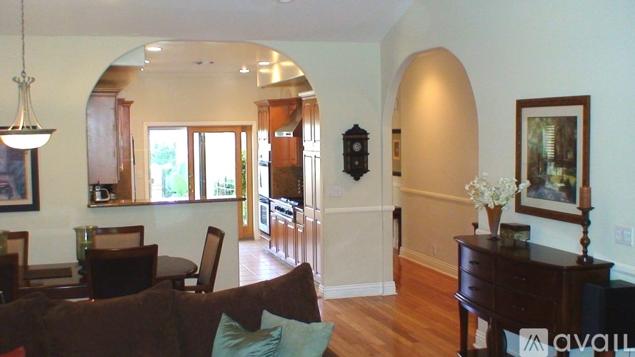 A living room with a couch, chairs, and a piano.