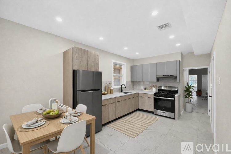 A modern kitchen with a dining table set for two.