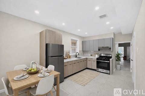 A modern kitchen with a dining table set for two.