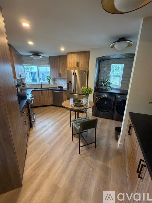 A kitchen with wooden floors and a ceiling fan.