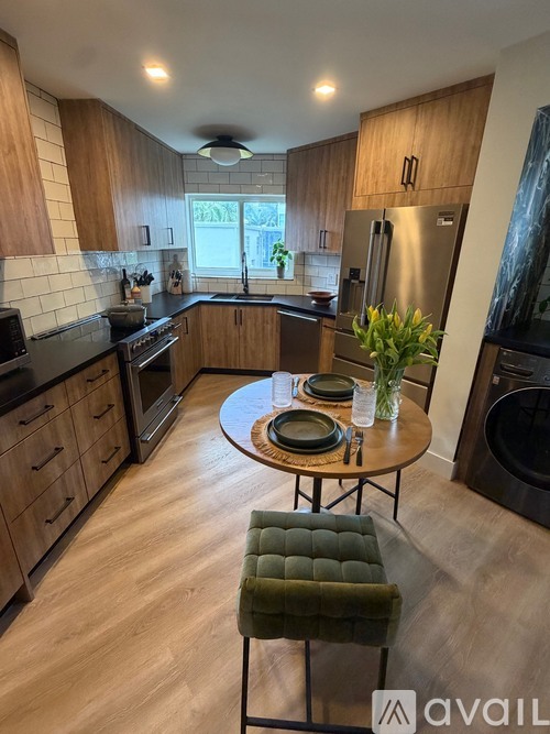 A kitchen with wooden cabinets and a green stool.