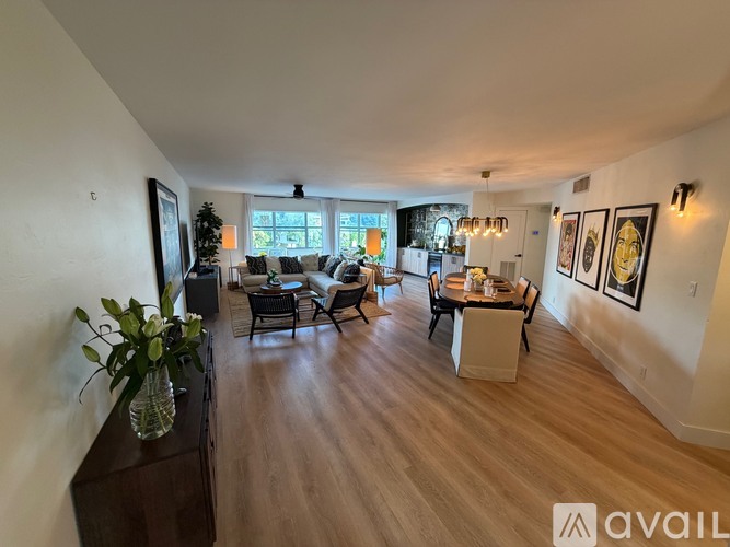 A living room with a dining table and chairs.