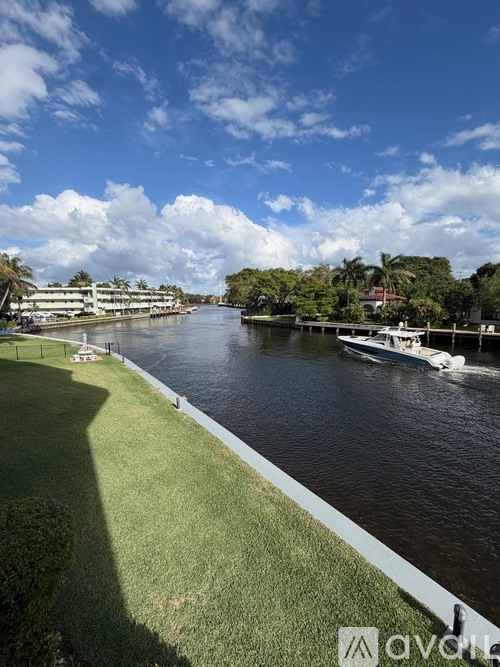 A river flows through a city with boats and buildings on the other side.