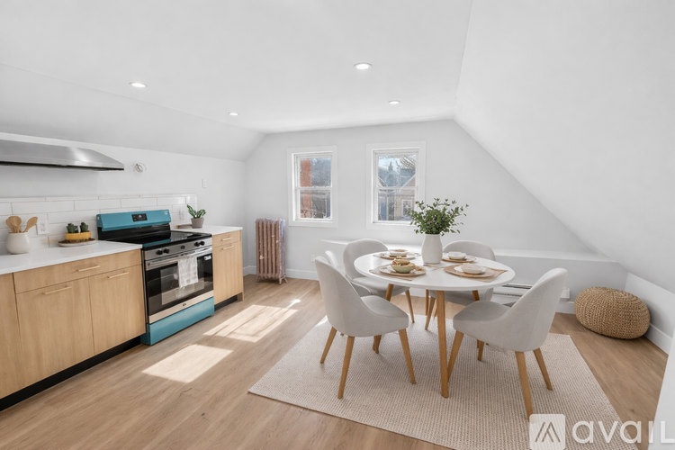 A modern kitchen with a dining table set for four.