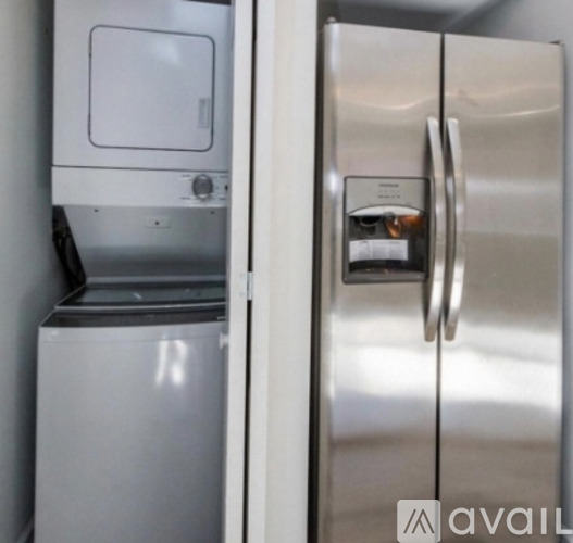 A stainless steel refrigerator with its door open and a bottle of wine in it.