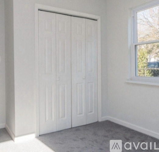 A white door in a room with a window.