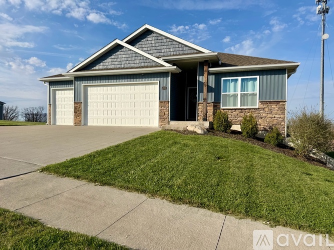 A house with a garage and a driveway in front.