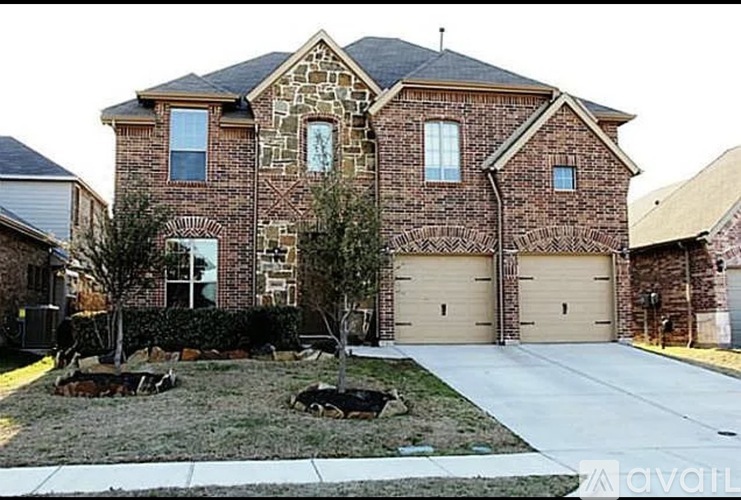 A large brick house with a stone facade and a grey roof.