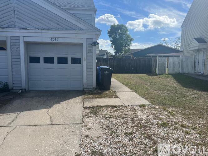 A white garage with the number 123225 on it.