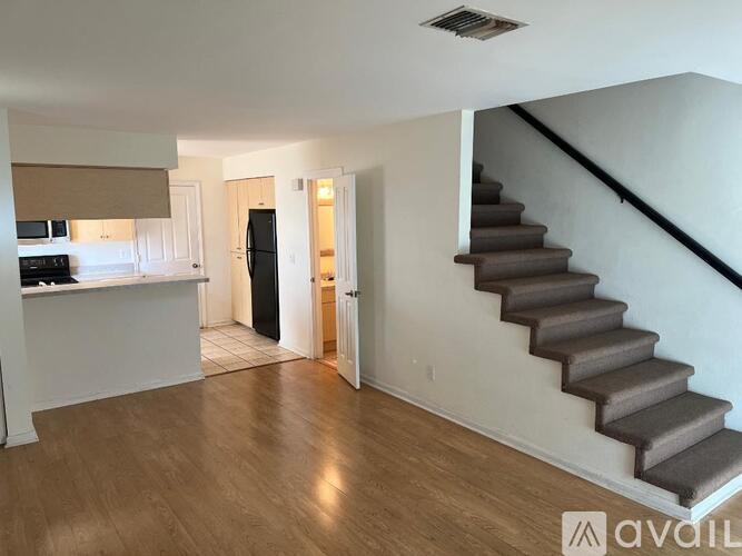 A living room with a staircase leading to the upper floor.