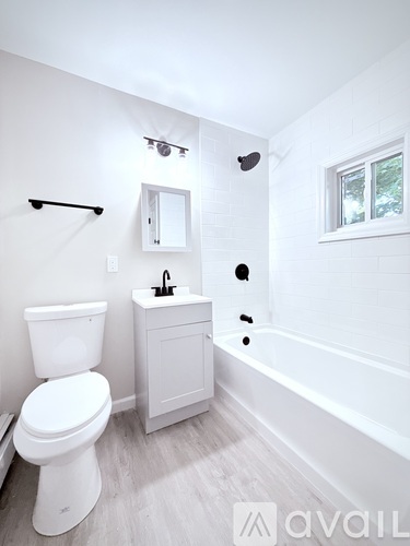 A white toilet sits next to a sink in a small bathroom.